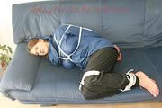 Katharina tied, gagged and hooded (breath control) on a sofa wearing sexy shiny nylon rainwear (Pics)