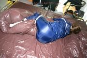 Stella tied and gagged in shiny nylon rainwear