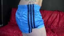 Watching ***NEW MODELL COURTNEY*** wearing a sexy lightblue shiny nylon shorts and a black top being tied and gagged overhead with ropes and a ballgag (Video)
