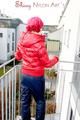 Marlin posing on a balcony wearing sexy black shiny nylon rainpants and a red down jacket (Pics)