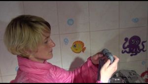 Sonja ties and gagges herself in the bath tub with cuffs wearing sexy shiny nylon downwear (Video)