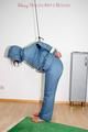 Jill tied, gagged and hooded wearing a shiny blue downwear (Pics)