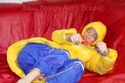 Sonja tied, gagged and hooded on a sofa wearing a sexy blue rain pants and a yellow downwear jacket (Pics)