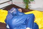 Lucy ties, gagges and hoodes herself on a bed wearing a sexy AGU rainnwear combination (Pics)