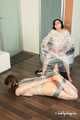 Anni Bay and Dakota - one wrapped to the armchair, another hogtaped on the floor