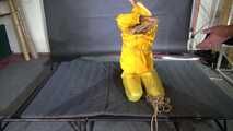 Ms Ungeniert tied and gagged in shiny nylon Rainwear trying to escape