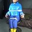 Sexy Pia being tied and gagged with ropes and a cloth gag on a hairdressers chair wearing a sexy blue shiny nylon rainpants and a lightblue downjacket (Video)