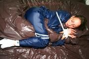 Stella tied and gagged in shiny nylon rainwear