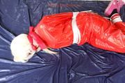Nina tied and gagged in a shiny red PVC suit