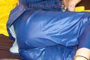 Lucy ties, gagges and hoodes herself on a bed wearing a sexy AGU rainnwear combination (Pics)