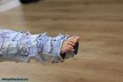 Hot jeans girl cuffed on a chair