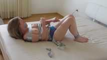Maria in tape on bed 4/4