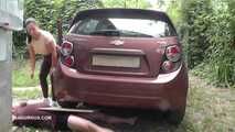Mistress Jenna stands on the slave with a car while smoking in the slave's mouth B
