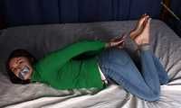 Roxana hogtied on bed