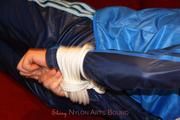 Isabelle tied and gagged in shiny nylon clothes