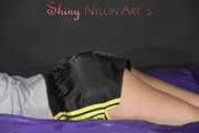 Watching Pia preparing her bed wearing a sexy black shiny nylon shorts and a grey tshirt (Pics)