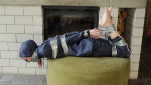 Rachel Adams bound and gagged by an Intruder in shiny Rainwear
