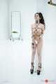 Kinbaku waitress in shiny metal