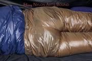 Samantha tied and gagged on bed wearing a brown shiny nylon downpanst and a blue downjacket (Pics)