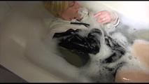 Sonja ties and gagges herself in a bath tub wearing a black shiny nylon shorts and a rain jacket (Video)