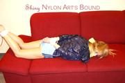 Samantha tied and gagged on a sofa wearing a hot lightblue shiny nylon shorts and a very shiny blue rian jacket (Pics)