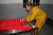 Watching Stella being tied and gagged with ropes and a ballgag on a operating table from Leonie both wearing sexy shiny nylon rainwear (Pics)