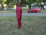 Watch Sandra taking a Walk during very hot Weather enjoying her rubberized oldschool Rainsuit