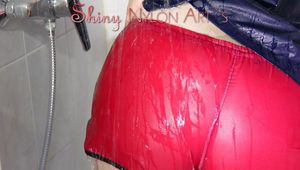 Jill wearing a sexy red shiny nylon shorts and a black rain jacket in the shower having fun with the water and clothes (Pics)