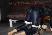Watching sexy Sandra wearing a sexy blue shiny nylon pants and a rain jacket being tied and gagged with ropes and a clothgag on a stool (Pics)