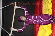 Watching sexy Sonja wearing a supersexy purple shiny nylon rainwear combination being tied and gagged overhead with ropes and a clothgag (Pics)