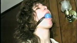 ERICA IS RING GAGGED, MOUTH STUFFED, CLEAVE GAGGED & TIED WITH BLACK NYLON ROPE (D36-10)