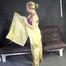 Watching sexy Sandra putting on three rainwear combinations one over the other, hooded (Video)