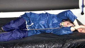 Lucy tied with cuffs overhead and gagged with a clothgag wearing sexy blue rain pants and a raincoat (Pics)