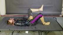 Lana handcuffed and gagged wearing a shiny nylon Windbreaker