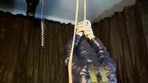Sebastien tied by the hands in a down jacket.