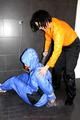 Jill bound and gagged by Simone in shiny nylon rainwear