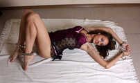 Barefoot Ekaterina in lingerie, handcuffed and legcuffed, poses on the floor