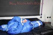 Lucy wearing sexy lightblue downwear tied and gagged with ropes and cloth gag on a bed (Pics)
