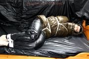 Jill tied and gagged in a shiny nylon down coat
