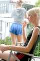 Jenny and a friend of her sitting on the balcony with eachother wearing sexy shiny nylon shorts ans tops (Pics)