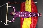 Watching sexy Sonja wearing a supersexy purple shiny nylon rainwear combination being tied and gagged overhead with ropes and a clothgag (Pics)