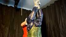 Sebastien tied by the hands in a down jacket.