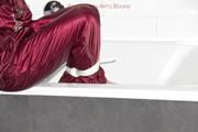 Isabelle tied and gagged in a shiny downwear