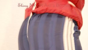 Jill tied and gagged on a stairway wearing a sexy blue shiny nylon shorts and a red rain jacket (Pics)