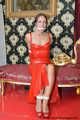Miss Scarlett bound and gagged in a long red Latex dress