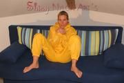 Sexy blonde archive girl posing and lolling on a sofa wearing sexy yellow rainwear over nothing (Pics)
