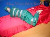Jill tied, gagged and hooded on a sofa with tape wearing supersexy shiny nylon oldschool rainwear (Pics)