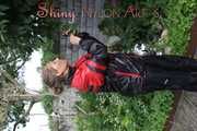 Watching sexy Sandra wearing a oldschool black/red shiny nylon rainwear combination while gardening outside (Pics)