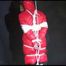 ***SEXY MARA*** wearing a supersexy black shiny nylon pants and a red shiny nylon down jacket with a coat being bound overhead with ropes and a ball gag (Video)