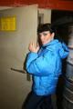 Jill posing in a cooling room wearing a shiny nylon rainpants and a down jacket (Pics)